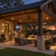 Covered patio with outdoor kitchen and fireplace on a fall evening in DFW