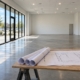 Vanilla shell retail space in DFW with finish-out plans on a sawhorse table